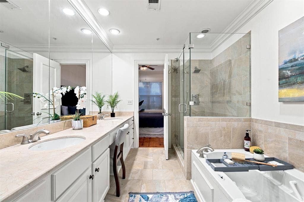 3303 Blackburn Street, #306, Dallas, TX 75204 Double vanity with undermount sinks, recessed lighting, glass-enclosed shower, and built-in soaking tub