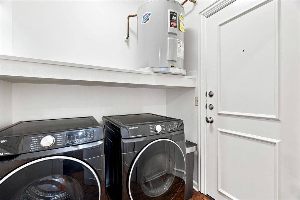 3303 Blackburn Street, #306, Dallas, TX 75204 Laundry area with a water heater, built-in shelving, and wood-finish flooring