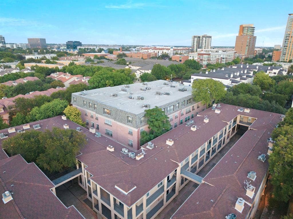 3303 Blackburn Street, #306, Dallas, TX 75204 Aerial perspective showcasing multiple buildings with pitched roofs and surrounding mature trees