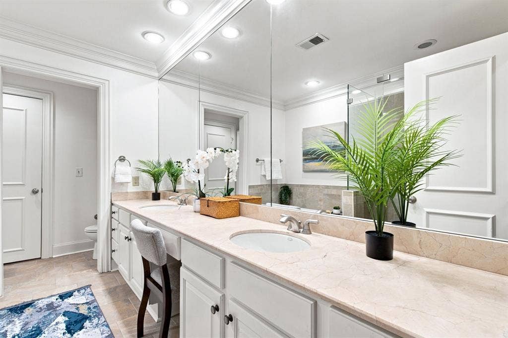 3303 Blackburn Street, #306, Dallas, TX 75204 Dual vanity with integrated sinks, light stone countertop, and ample storage cabinetry