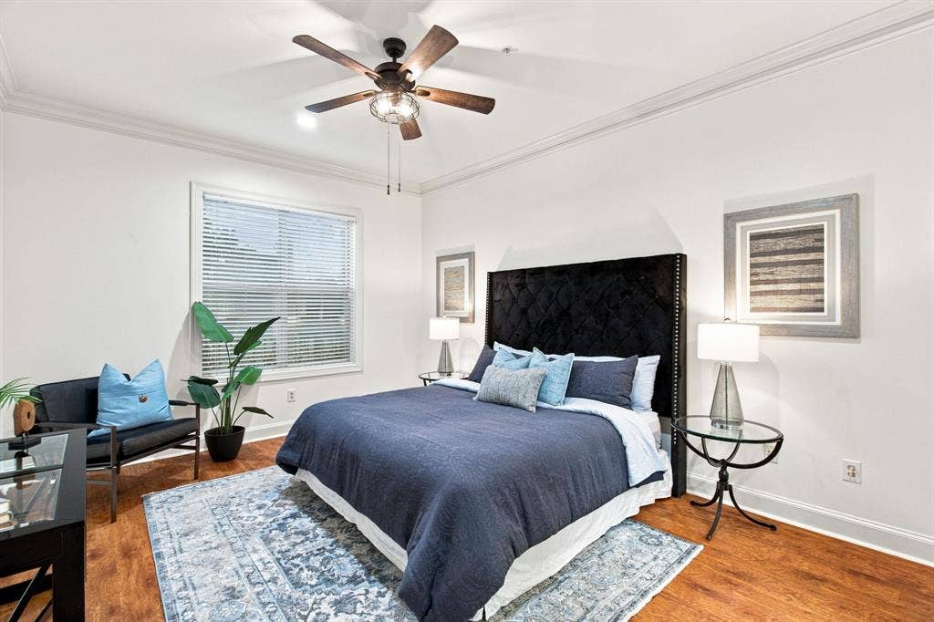 3303 Blackburn Street, #306, Dallas, TX 75204 Primary bedroom with ensuite, wood-finish flooring, crown molding, and a ceiling fan with integrated lighting