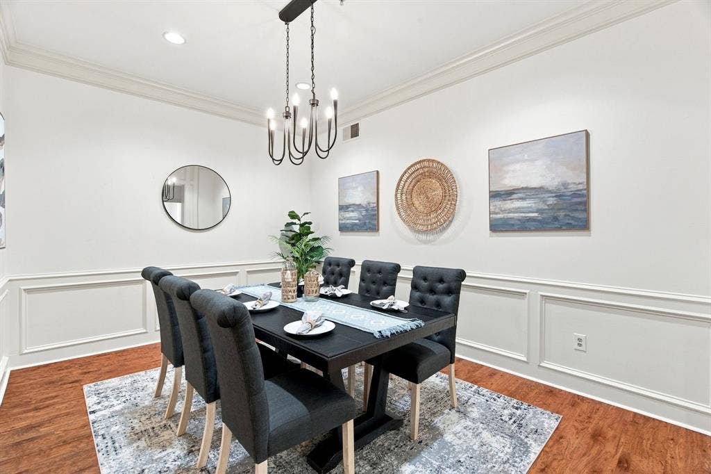 3303 Blackburn Street, #306, Dallas, TX 75204 Crown molding and wainscoting paneling complement the wood-finish flooring