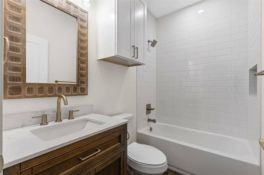 Full bath with toilet, vanity, and shower / bathtub combination
