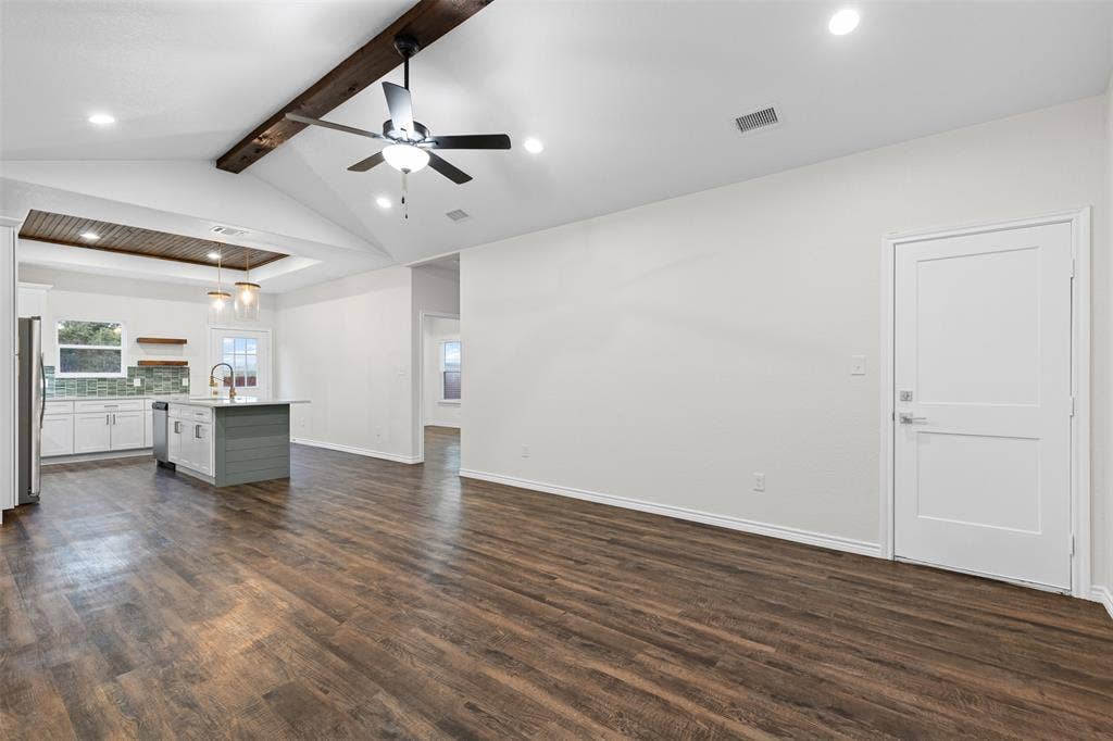 Unfurnished living room with a sink, recessed lighting, dark wood finished floors, a ceiling fan, and baseboards