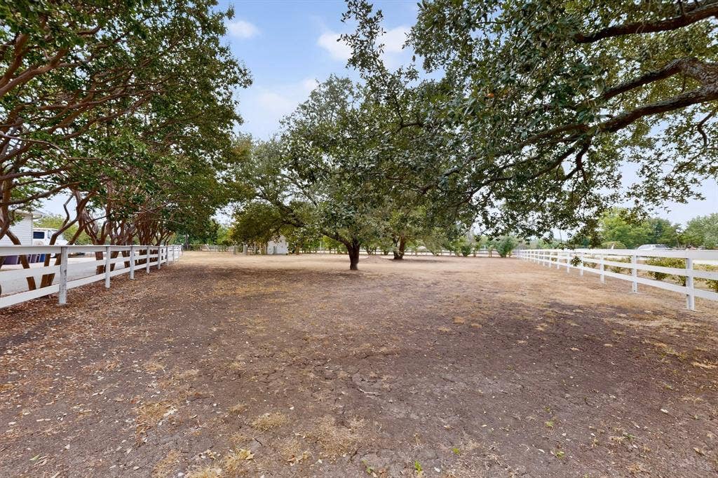 2 Trailridge Drive, Melissa, TX 75454 Expansive open lot featuring mature trees and white fencing