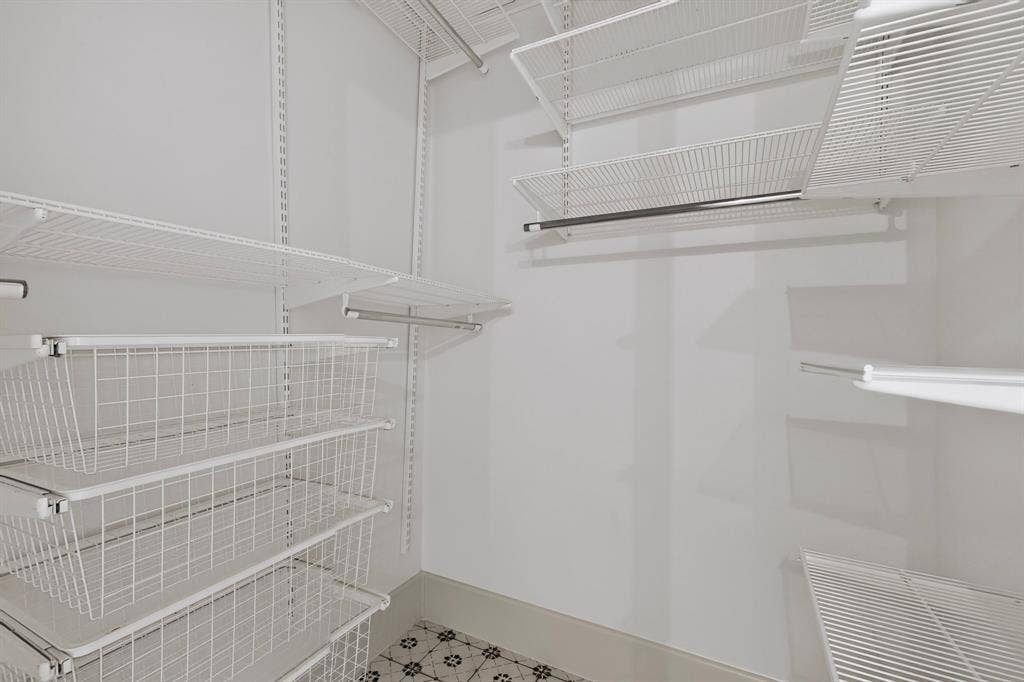 2 Trailridge Drive, Melissa, TX 75454 Adjustable wire shelving system with integrated wire baskets, hanging rods, and patterned floor tile