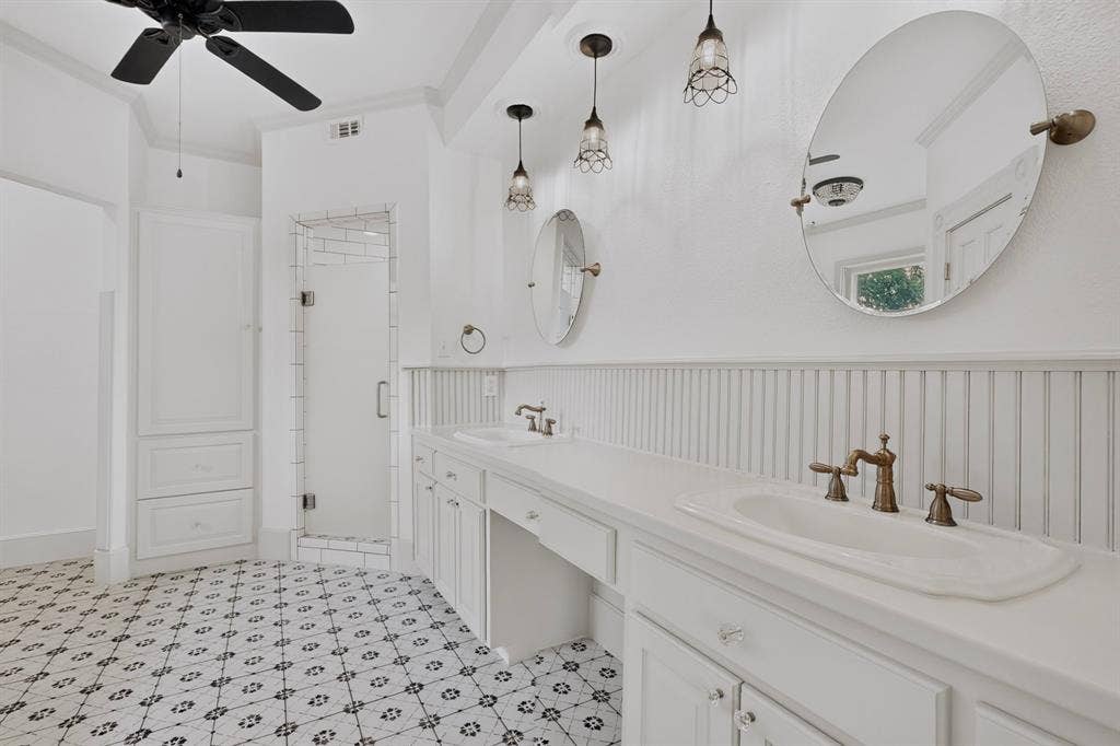 2 Trailridge Drive, Melissa, TX 75454 Dual vanity with integrated sinks, custom white cabinetry, and beadboard wainscoting