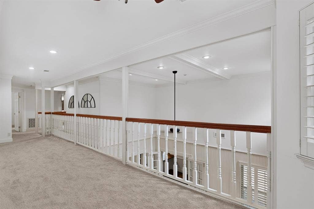 2 Trailridge Drive, Melissa, TX 75454 Carpeted hallway with white railing and wood-finish top rail, recessed lighting, and crown molding