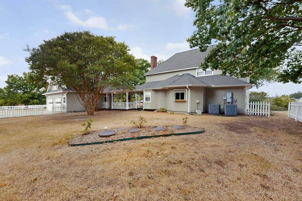 2 Trailridge Drive, Melissa, TX 75454 Two-story residence with light-colored siding, a covered porch, an attached two-car garage, and a picket fence