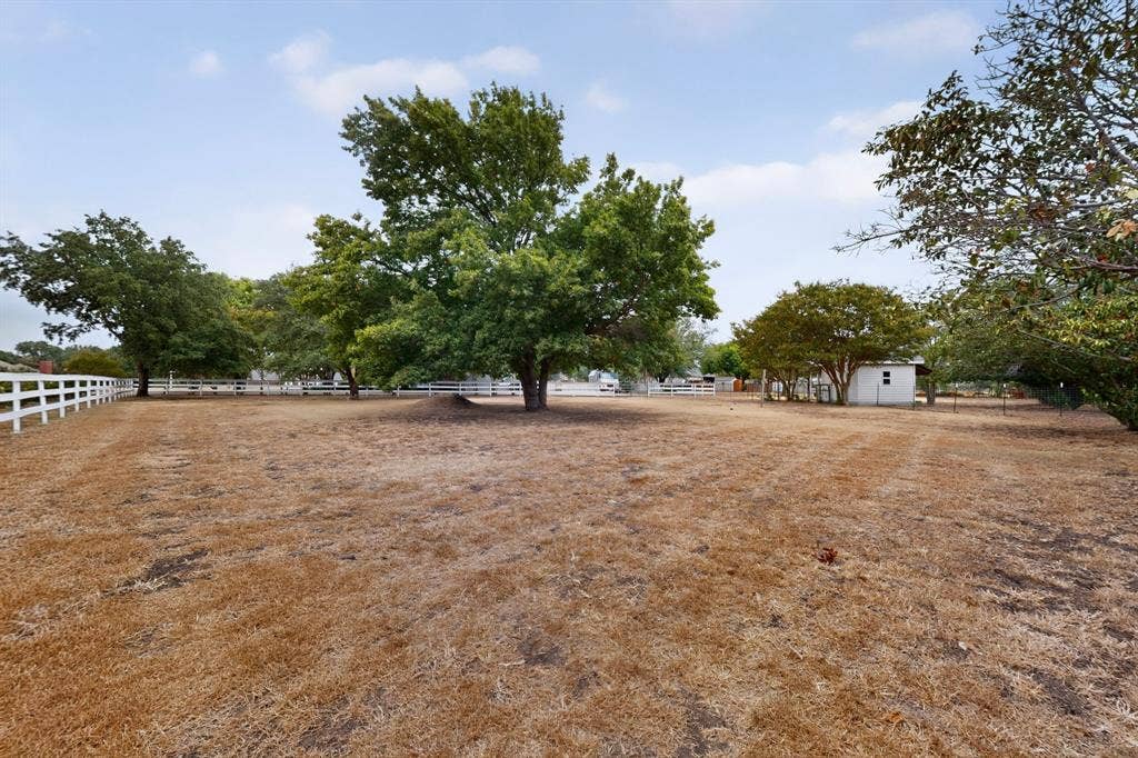 2 Trailridge Drive, Melissa, TX 75454 Expansive open land with mature trees and a white post-and-rail fence