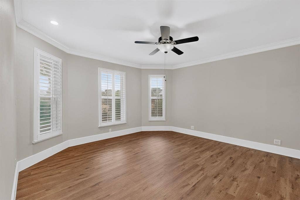 2 Trailridge Drive, Melissa, TX 75454 Wood-finish flooring throughout, multiple windows with plantation shutters, recessed ceiling lighting, crown molding, and a ceiling fan with light fixture