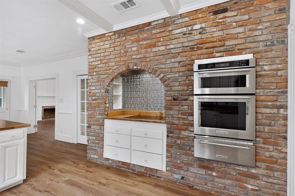 2 Trailridge Drive, Melissa, TX 75454 Exposed brick wall with an arched niche featuring a tin tile backsplash