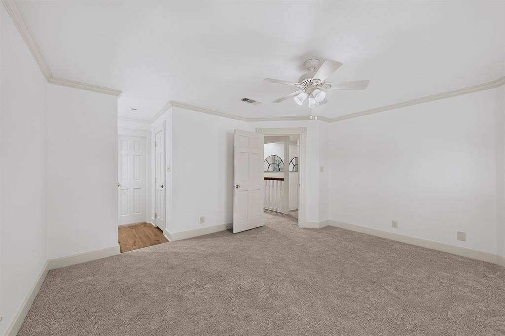 2 Trailridge Drive, Melissa, TX 75454 Expansive room featuring neutral carpet, crown molding, a ceiling fan, and white paneled doors