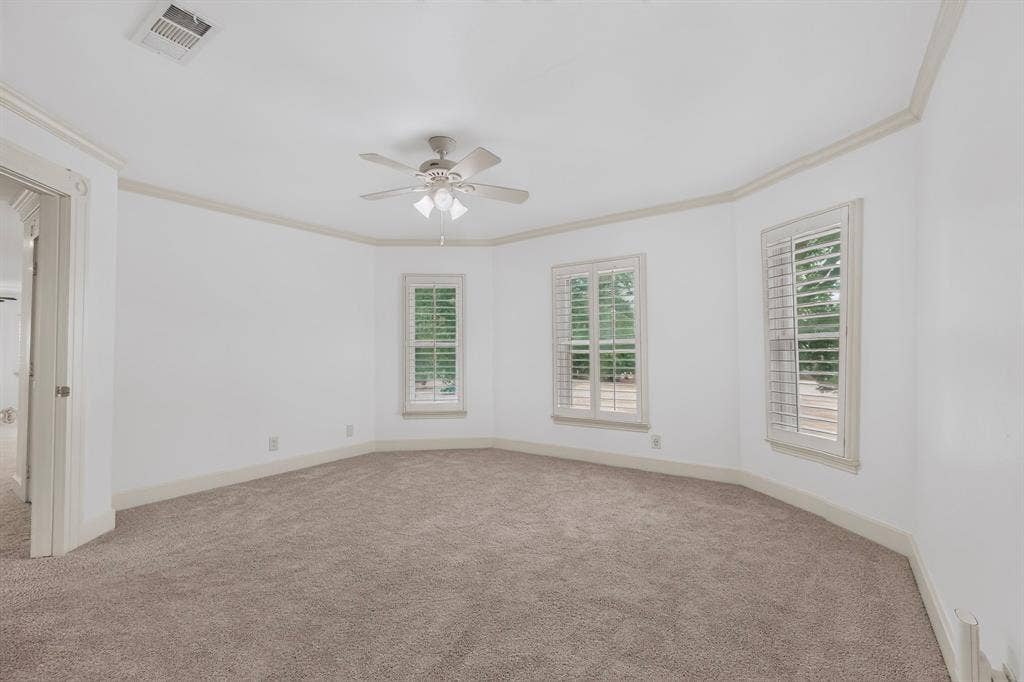 2 Trailridge Drive, Melissa, TX 75454 Neutral-toned carpeted flooring, multiple windows with plantation shutters, crown molding, and a ceiling fan with integrated lighting