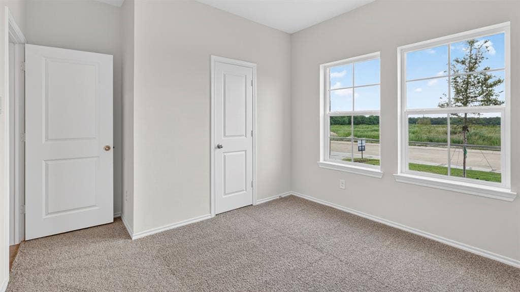1920 Freeman Street, Tyler, TX 75704 Bright interior space featuring two panel doors, light gray wall paint, and gray carpet flooring