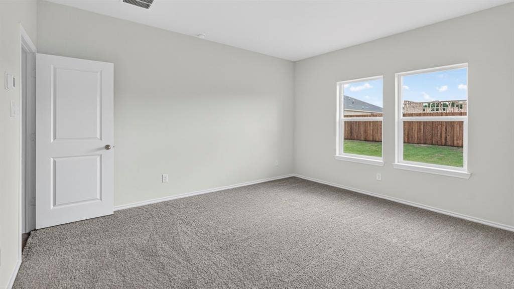 1920 Freeman Street, Tyler, TX 75704 Carpeted room featuring light gray walls, white trim, and two paneled interior doors