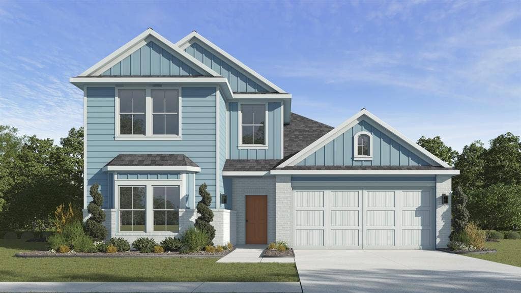 1920 Freeman Street, Tyler, TX 75704 Two-story residence featuring light blue siding, a two-car garage, and white stone accents