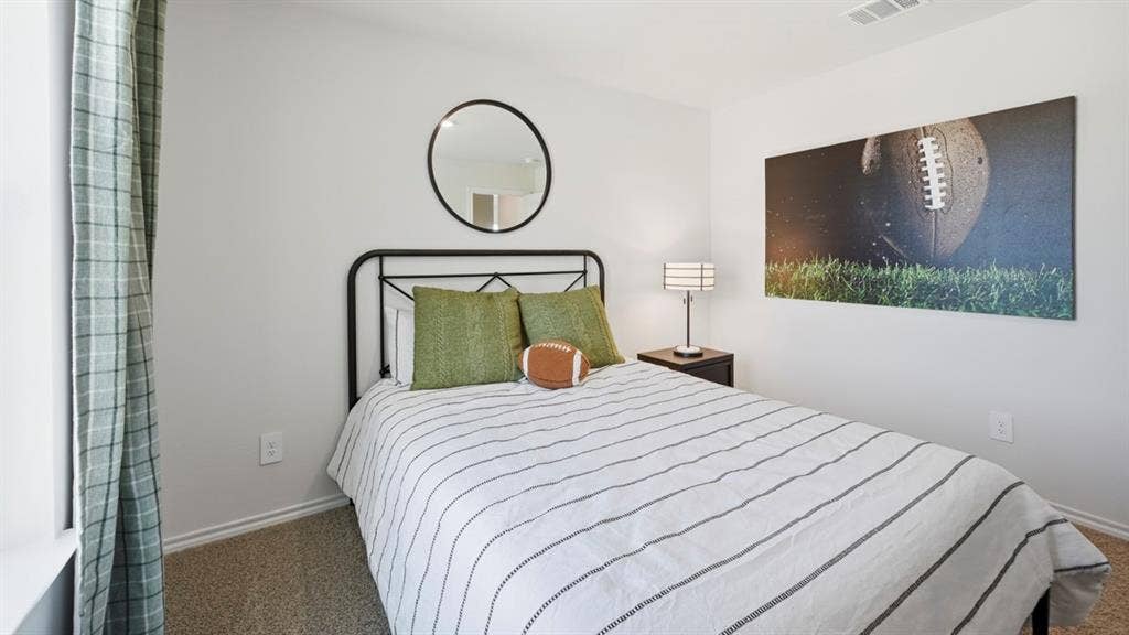 1932 Freeman Street, Tyler, TX 75704 Bedroom featuring neutral wall paint, textured carpeting, a visible window, and a ceiling vent