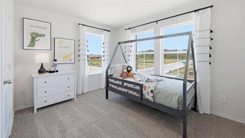 1932 Freeman Street, Tyler, TX 75704 Bright interior room featuring a neutral carpet, multiple windows, white baseboards, and a white interior door
