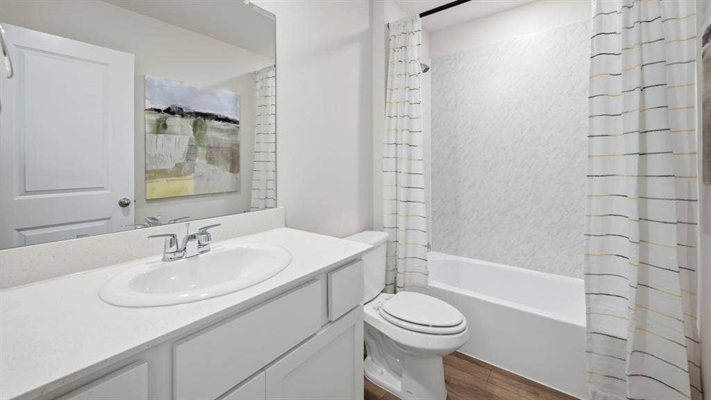 1932 Freeman Street, Tyler, TX 75704 Bathroom featuring a single vanity with an integrated sink, polished chrome faucet, and expansive wall mirror