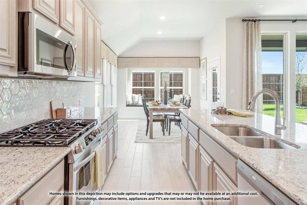 942 Cardinal Drive, Midlothian, TX 76065 Gourmet kitchen with stainless steel appliances, light-toned cabinetry, and speckled countertops