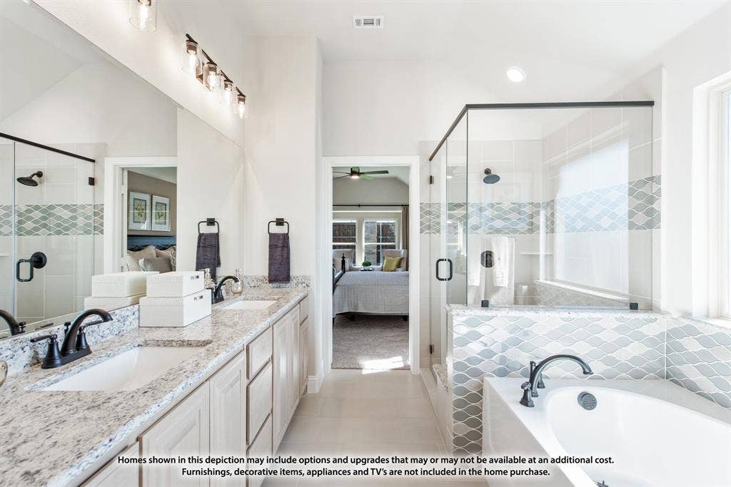 942 Cardinal Drive, Midlothian, TX 76065 Dual vanities with granite countertops, an oversized mirror, a glass-enclosed shower, a separate soaking tub, and tile flooring