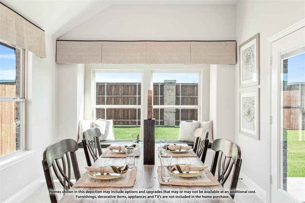942 Cardinal Drive, Midlothian, TX 76065 Vaulted ceiling, multiple windows, built-in window seating, glass panel door, and wood-finish flooring