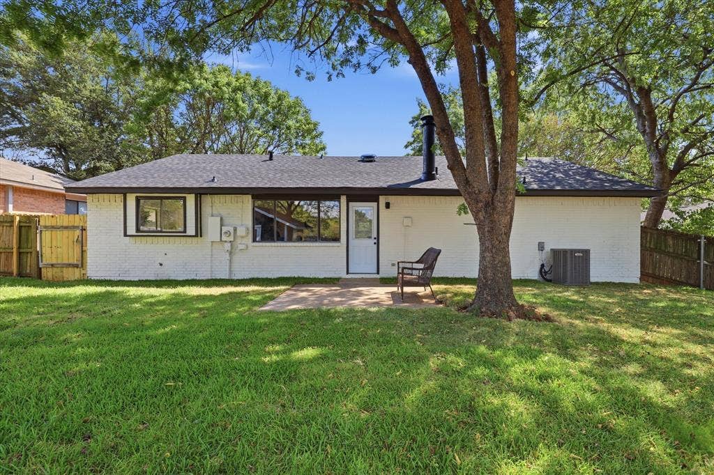 3405 Mill Ridge, Bedford, TX 76021 Expansive grassy backyard featuring a paved patio and mature trees