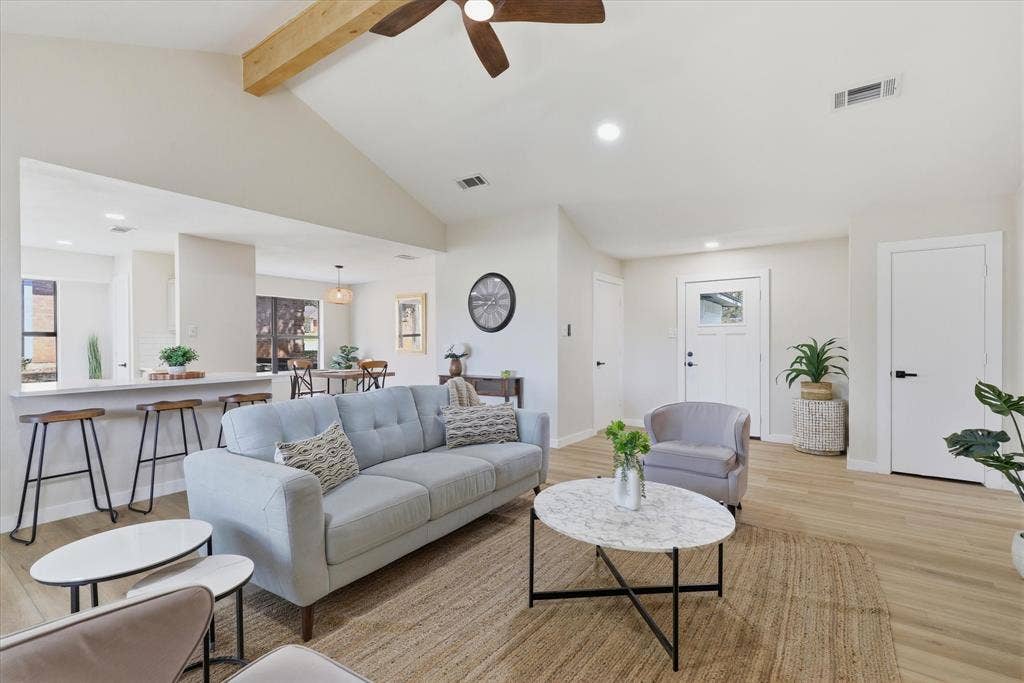 3405 Mill Ridge, Bedford, TX 76021 Vaulted ceiling with exposed wood beam, recessed lighting, wood-finish flooring, breakfast bar with seating, and a modern ceiling fan