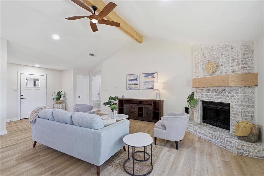 3405 Mill Ridge, Bedford, TX 76021 Vaulted ceiling with wood beam accent, wood-finish flooring, recessed lighting, and a whitewashed brick fireplace with a wood mantle