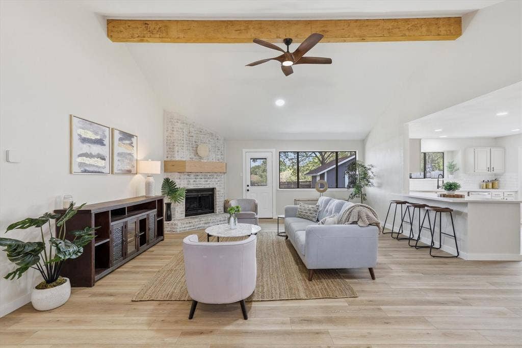 3405 Mill Ridge, Bedford, TX 76021 Vaulted ceiling with exposed wood beam, wood-finish flooring, brick fireplace with wood mantel, built-in kitchen island with seating, and recessed lighting