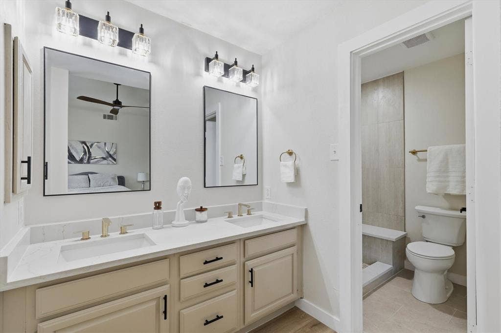 3405 Mill Ridge, Bedford, TX 76021 Dual vanity with white countertops, undermount sinks, and gold-finish fixtures