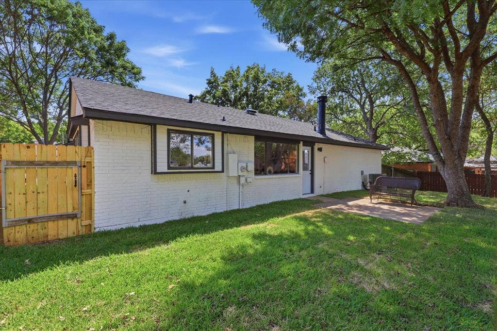 3405 Mill Ridge, Bedford, TX 76021 White painted brick exterior with black trim and a dark shingle roof