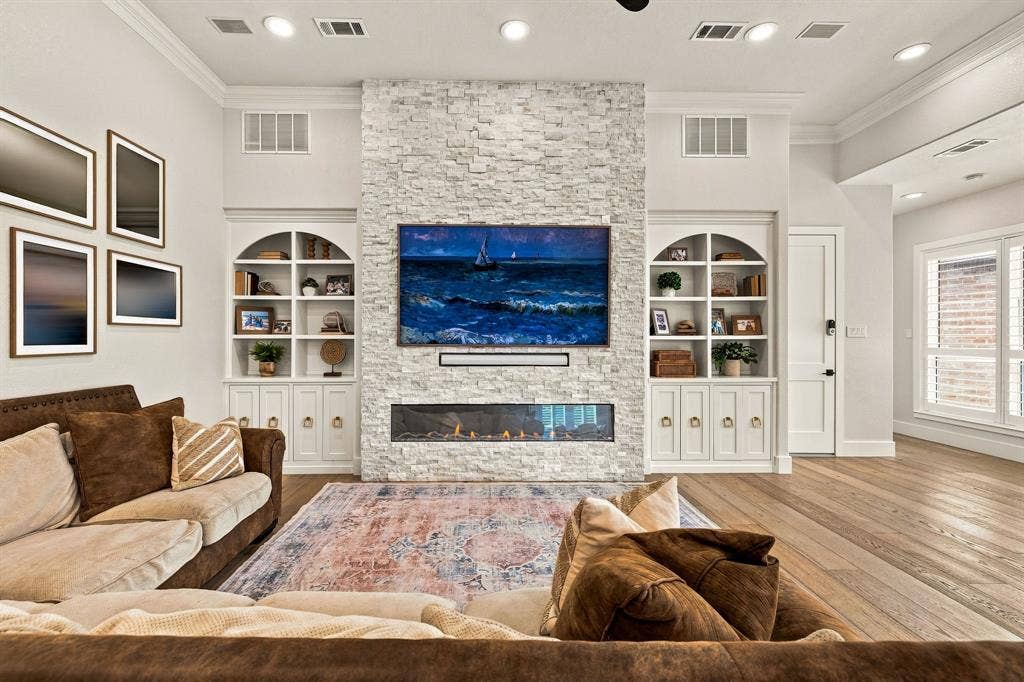 5941 Tiburon Drive, Plano, TX 75093 Stacked stone fireplace with an integrated linear fire feature
