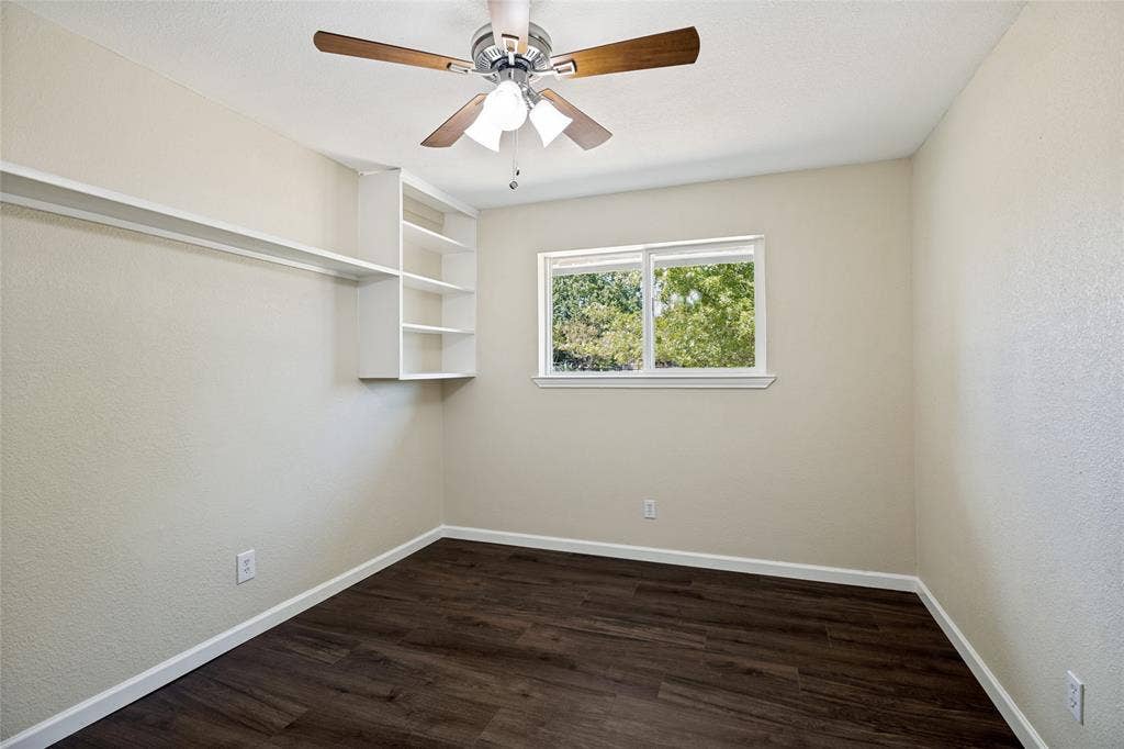 2406 County Road 852, McKinney, TX 75071 Wood-finish flooring, built-in shelving, white trim, recessed window, and a ceiling fan with integrated lighting