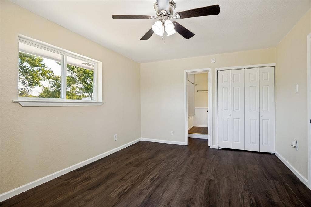 2406 County Road 852, McKinney, TX 75071 Wood-finish flooring, bright window, ceiling fan with light, bi-fold closet doors, and light-toned wall paint