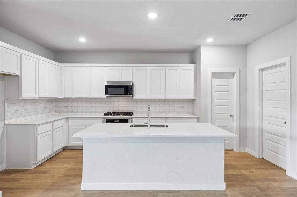 Kitchen in the Oscar home plan by Trophy Signature Homes – REPRESENTATIVE PHOTO