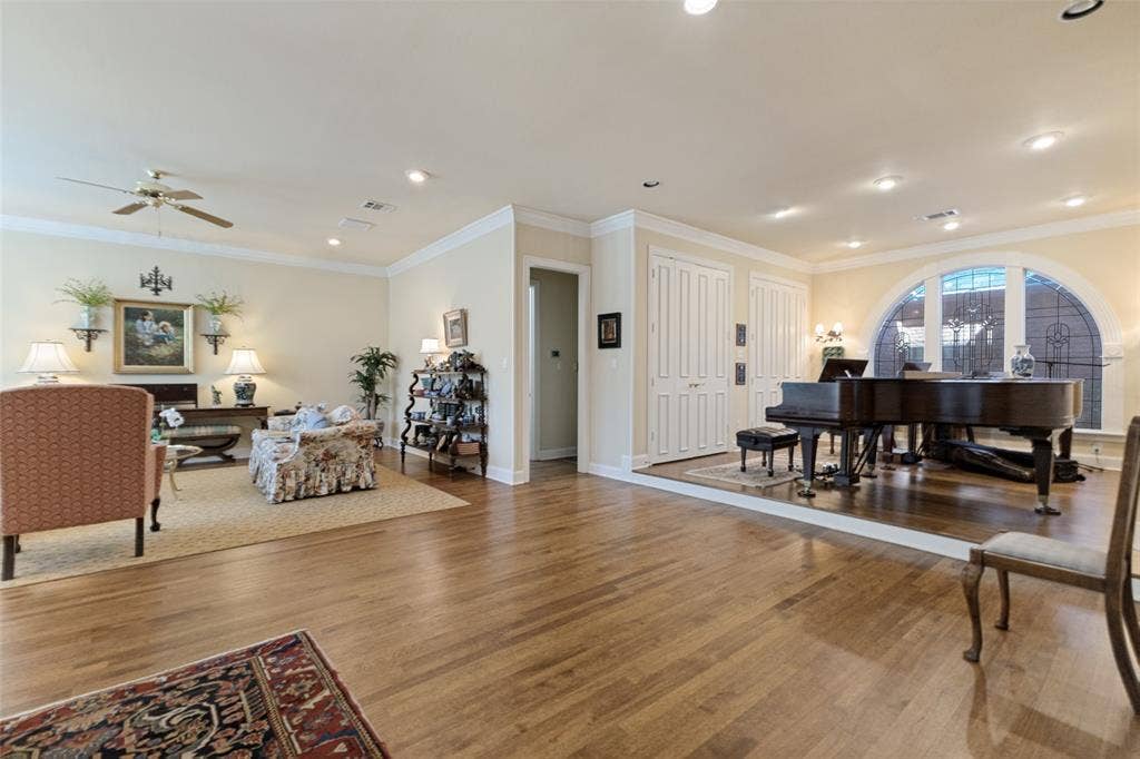 12012 Excelsior Way, Dallas, TX 75230 Hardwood flooring throughout, recessed lighting, crown molding, arched window with decorative grille, and built-in storage closets