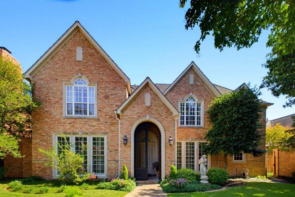 12012 Excelsior Way, Dallas, TX 75230 Brick facade with multiple gables, arched entry, and varied window designs, set amidst mature landscaping