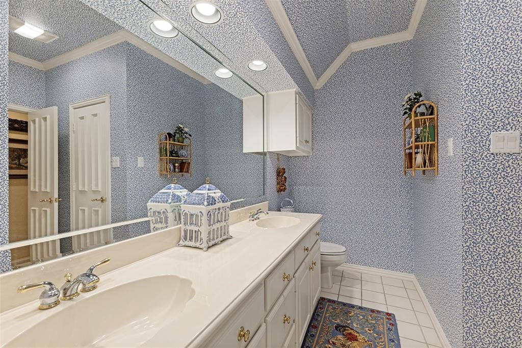 12012 Excelsior Way, Dallas, TX 75230 Dual vanity with under-mount sinks, white cabinetry, and a full-width mirror