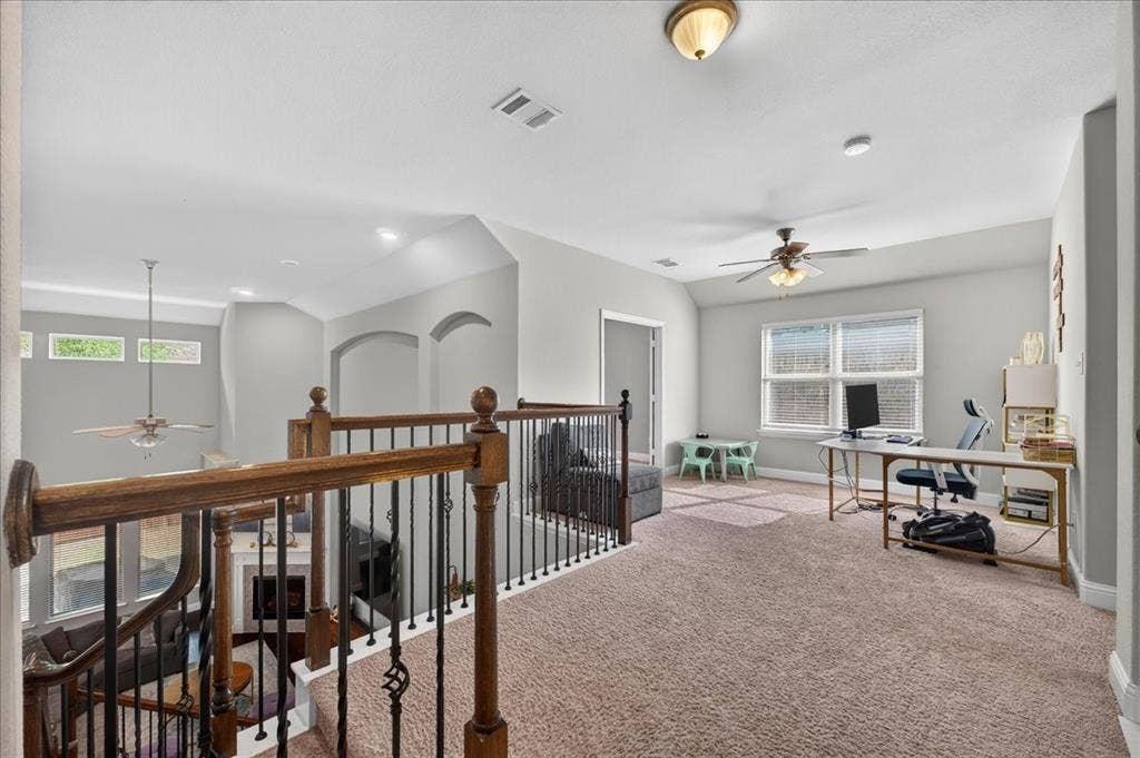 8712 Mccutchins Drive, McKinney, TX 75070 Spacious carpeted landing featuring a ceiling fan, recessed lighting, and a window with blinds