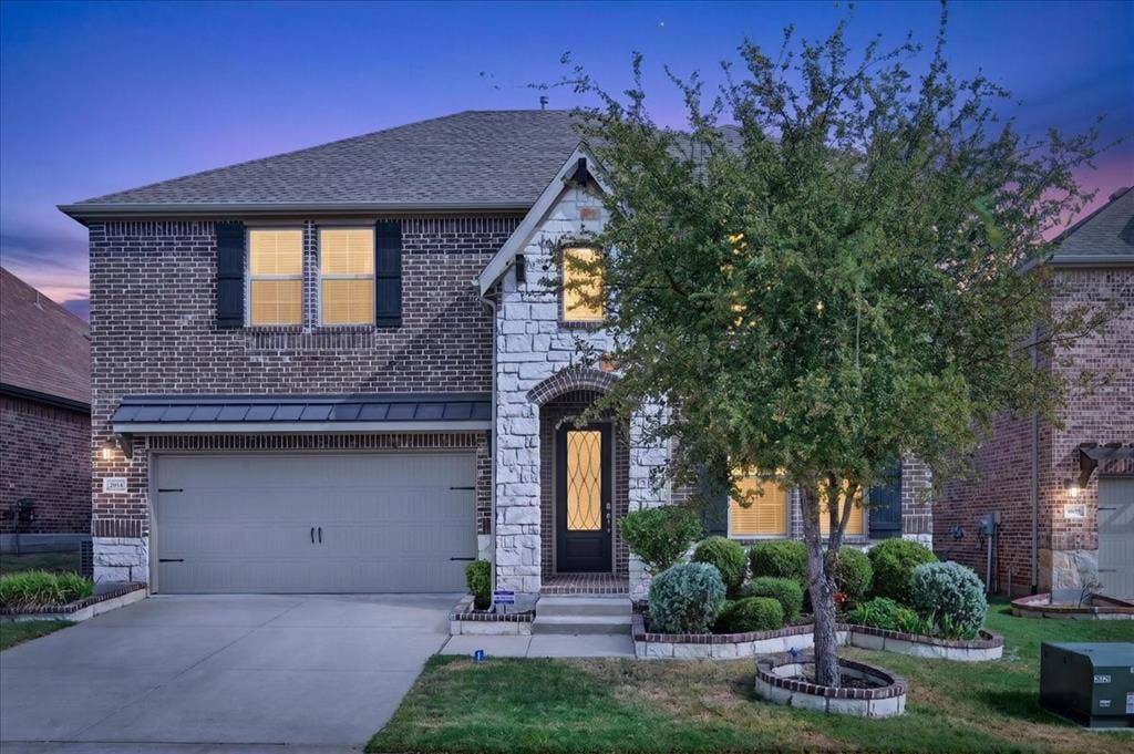 8712 Mccutchins Drive, McKinney, TX 75070 Brick and stone facade with a two-car garage