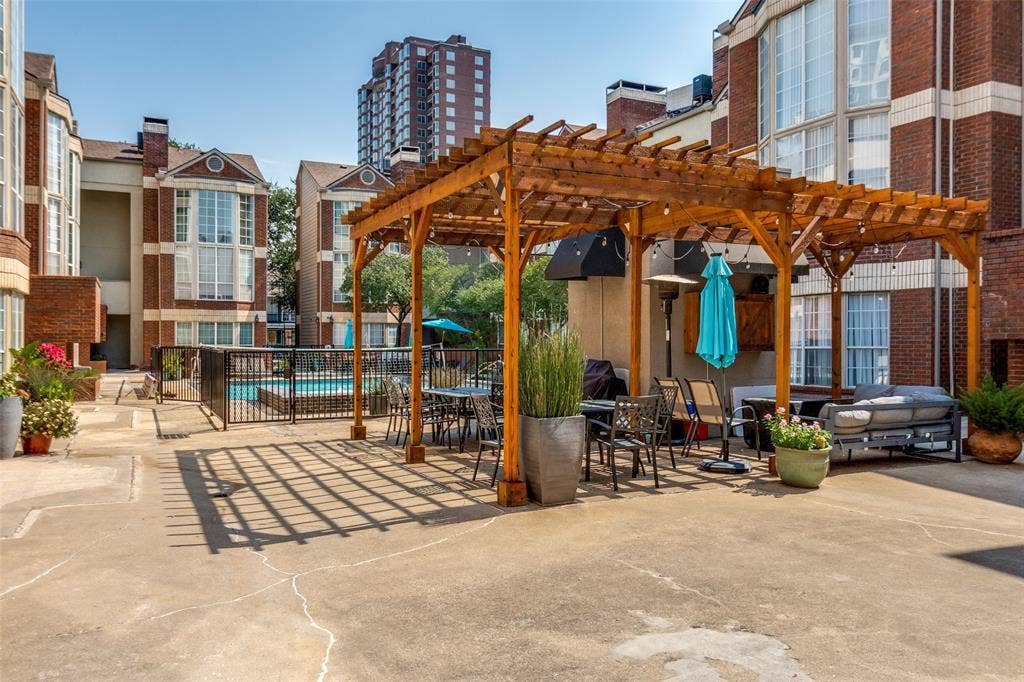 3100 Cole Avenue, #213, Dallas, TX 75204 View of patio featuring a pergola, a community pool, and outdoor dining space