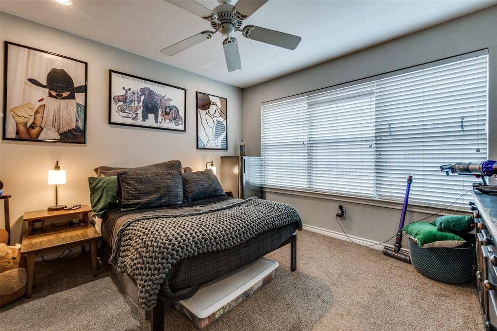 3100 Cole Avenue, #213, Dallas, TX 75204 Bedroom featuring carpet flooring and a ceiling fan