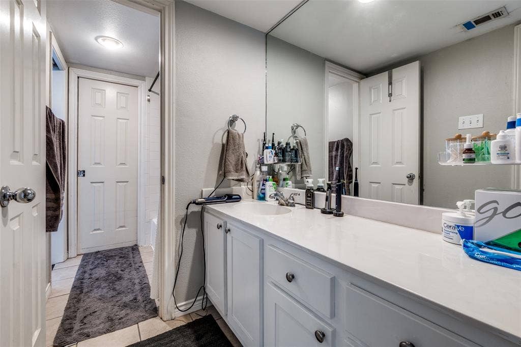 3100 Cole Avenue, #213, Dallas, TX 75204 Bathroom with vanity and light tile patterned floors
