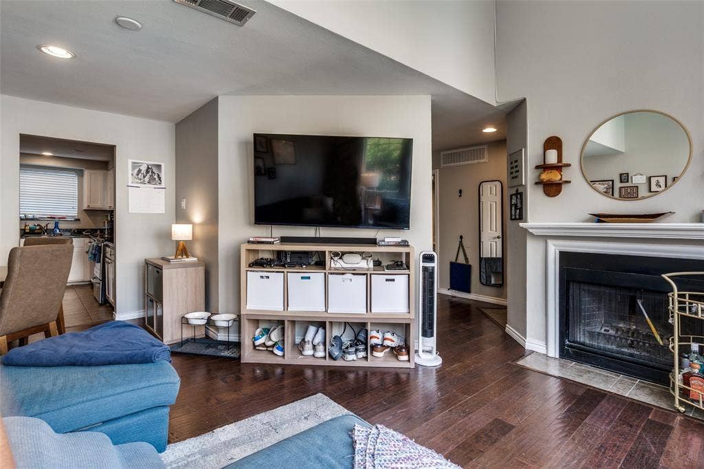 3100 Cole Avenue, #213, Dallas, TX 75204 Living area featuring recessed lighting, hardwood / wood-style floors, and a fireplace with flush hearth