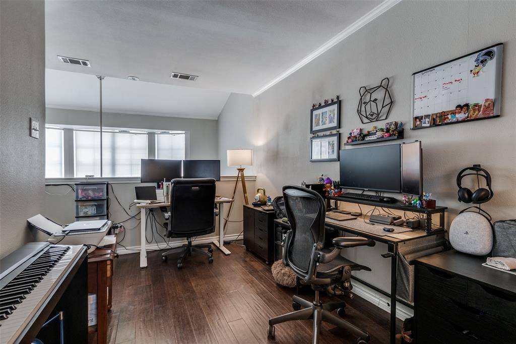 3100 Cole Avenue, #213, Dallas, TX 75204 Office with dark wood-style flooring, a textured wall, ornamental molding, and lofted ceiling