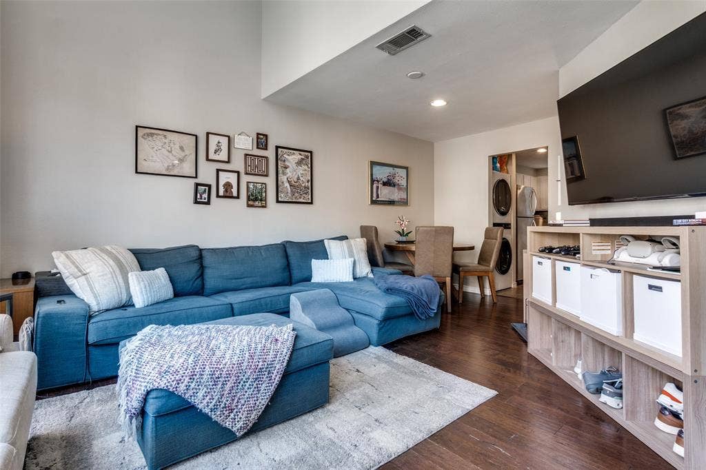 3100 Cole Avenue, #213, Dallas, TX 75204 Living room featuring dark wood-style floors, recessed lighting, and stacked washing machine and dryer
