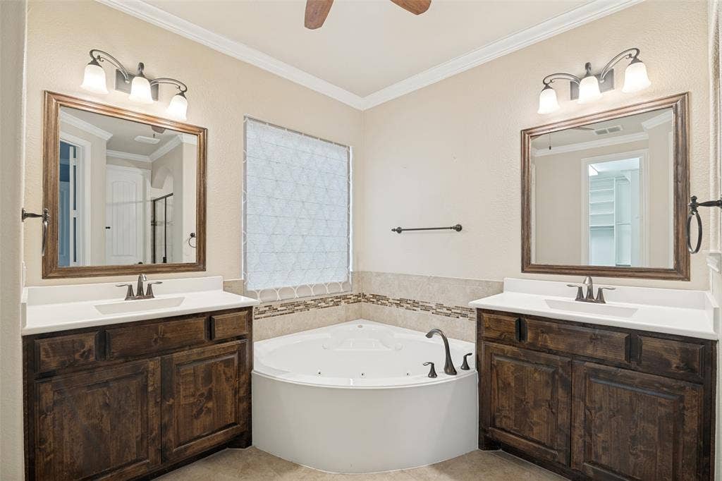 10002 Edgeway Circle, Rowlett, TX 75089 Primary bath has large jetted tub and two vanities.
