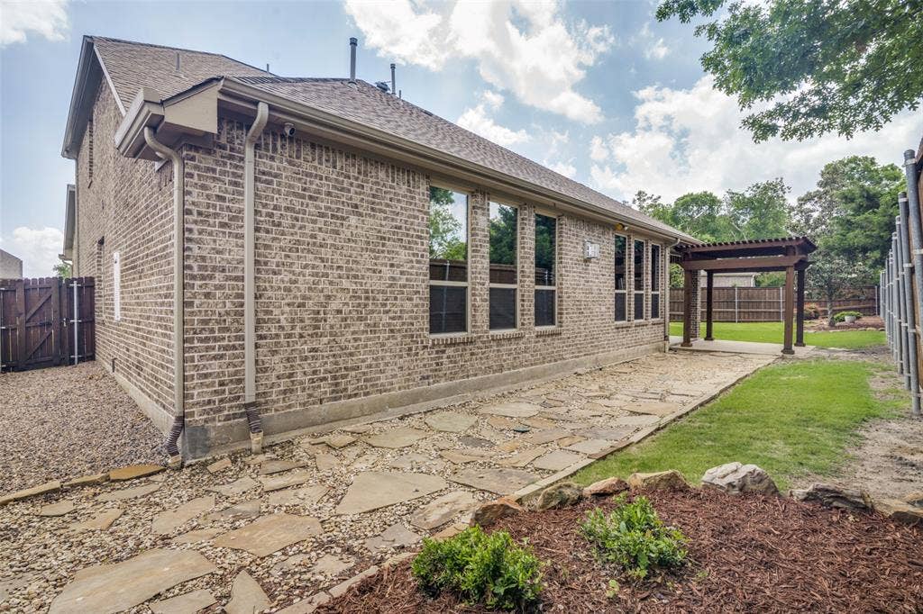 10002 Edgeway Circle, Rowlett, TX 75089 Rear of house facing patio with pergola and huge side yard.
